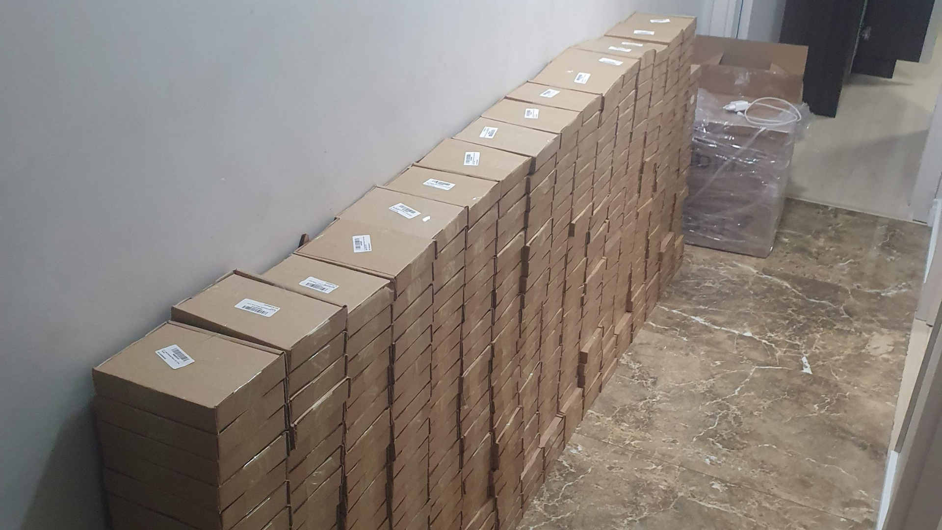 Corredor com uma longa fileira de caixas prontas para despacho
